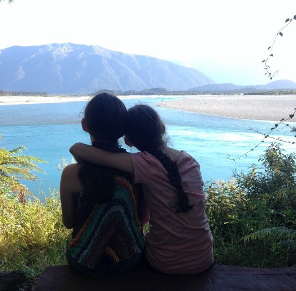 The girls sitting by the Haast River, New Zealand